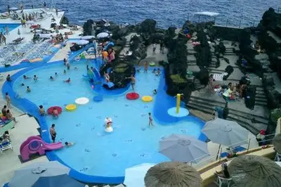 a water park with people in a water slide at PERFECT DUPLEX PISCINE Zone VIP Funchal in Funchal