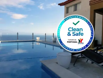 a sign that reads clean and safe next to a swimming pool at Casa Marias in Calheta