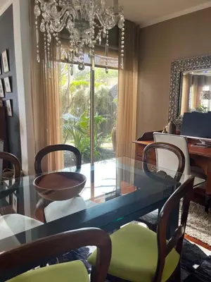 a dining room with a glass table and chairs at Casa Marias in Calheta