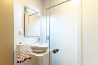 a bathroom with a sink and a mirror at BHF Residences Lotus in Calheta