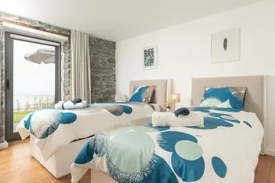 two twin beds in a bedroom with a window at BHF Residences Ying Yang in Calheta
