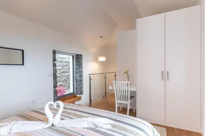 a bedroom with a bed and a white cabinet at BHF Residences Ying Yang in Calheta