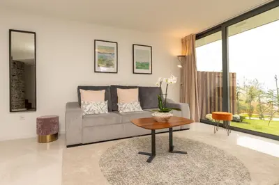 a living room with a couch and a table at BHF Residences Ying Yang in Calheta
