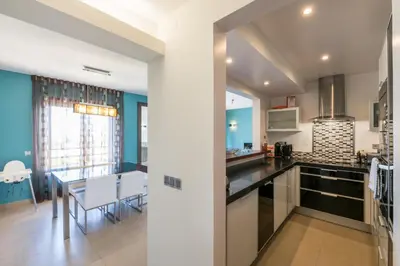 a kitchen and dining room with a table and chairs at Mar da Luz Terrace Apt 118 in Lagos