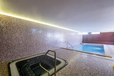 a bathroom with a swimming pool and a tub at Mar da Luz Terrace Apt 118 in Lagos