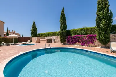 a swimming pool in a yard with trees and bushes at Mar da Luz Terrace Apt 118 in Lagos