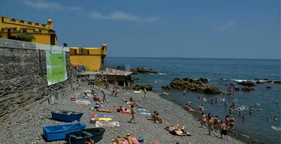 a group of people on a beach near the water at Apartment in the city of Funchal up 2 at 6 pers in Gaula