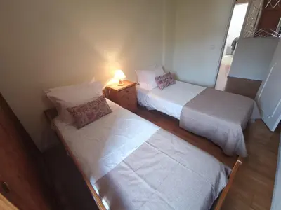 two beds in a room with a lamp on a table at Apartment in the city of Funchal up 2 at 6 pers in Gaula