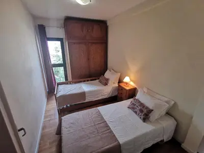 a small room with two beds and a window at Apartment in the city of Funchal up 2 at 6 pers in Gaula