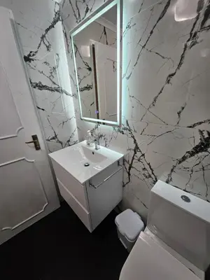 a white bathroom with a sink and a mirror at Apartment in the city of Funchal up 2 at 6 pers in Gaula