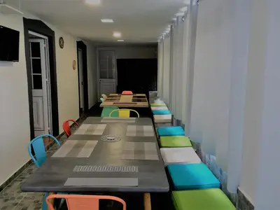 a row of tables and chairs in a room at La Casa de la Abuela in Ponta do Sol
