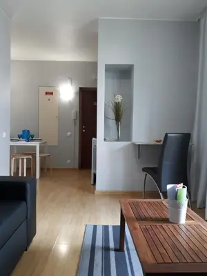 a living room with a couch and a table and a kitchen at Apartamentos América - Blue Sea II in Funchal