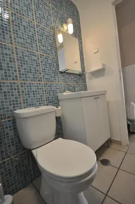 a bathroom with a white toilet and a mirror at Casa Azul in Barão de São João