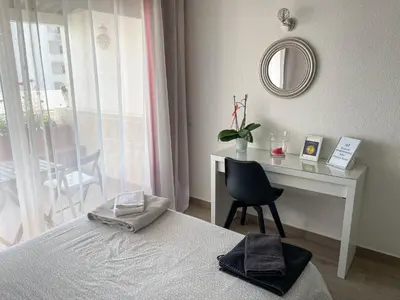 a bedroom with a desk and a bed and a chair at Casa Luztour in Luz