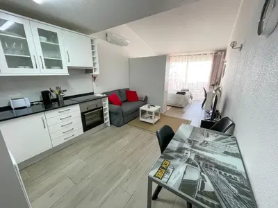 a kitchen and living room with a table and a couch at Casa Luztour in Luz