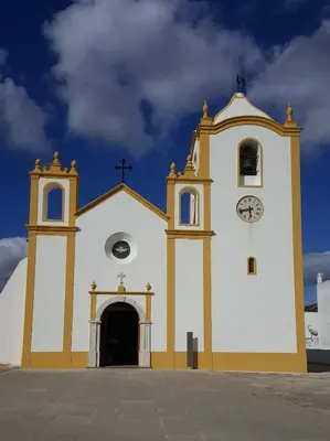 a church with a clock on the side of it at Casa Luztour in Luz