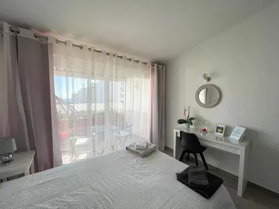 a bedroom with a bed and a desk and a window at Casa Luztour in Luz
