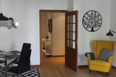 a dining room with a door and a table and chairs at Jasmineiro - Palms Palace Apartment in Funchal