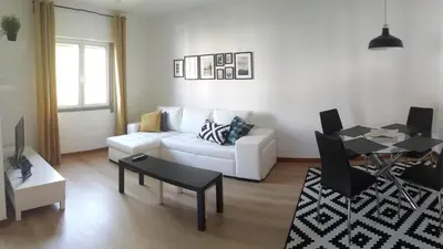 a living room with a white couch and a table at Jasmineiro - Palms Palace Apartment in Funchal