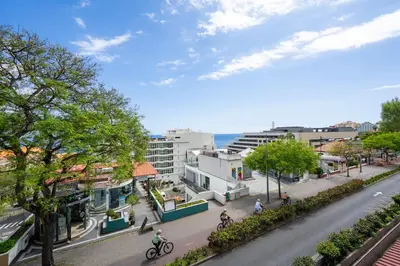 a street in a city with people riding bikes at Lido II by An Island Apart in Funchal