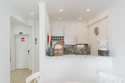 a kitchen with white cabinets and a stove at Lido II by An Island Apart in Funchal