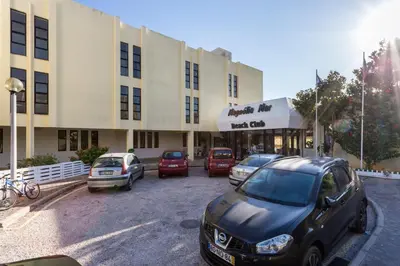 a parking lot with cars parked in front of a building at Magnoliamar 304 in Lagos
