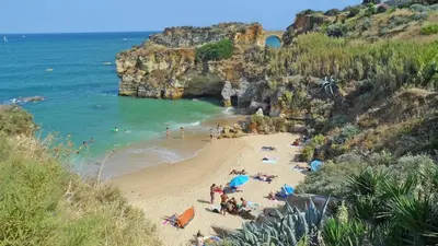a group of people on a beach near the ocean at Magnoliamar 304 in Lagos