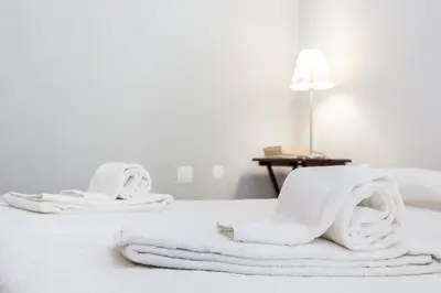 a pile of towels sitting on top of a bed at Magnoliamar 304 in Lagos