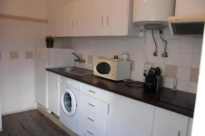 a kitchen with a washing machine and a microwave at Magnoliamar 304 in Lagos