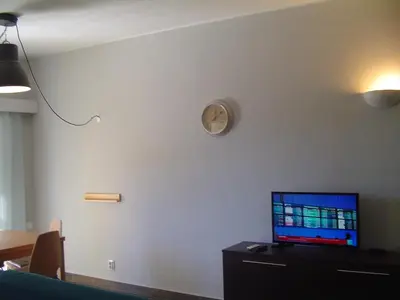 a living room with a clock on the wall at Magnoliamar 304 in Lagos