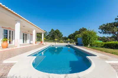 a swimming pool in the backyard of a house at Casa Naboo - Sunny Holiday Home with Pool in Aljezur