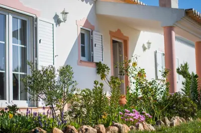 a house with a garden in front of it at Casa Naboo - Sunny Holiday Home with Pool in Aljezur
