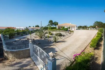 a driveway with a white fence and a house at Casa Naboo - Sunny Holiday Home with Pool in Aljezur