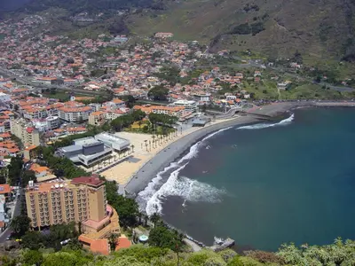 an aerial view of a city and the beach at Spot Matur Apartment in Machico