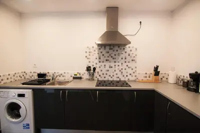 a kitchen with a sink and a microwave at O Cantinho do Zé in Funchal