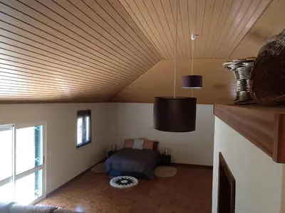 a room with a bed and a wooden ceiling at Danny's Rural Suite in Curral das Freiras