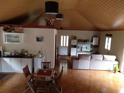 a living room with a couch and a table at Danny's Rural Suite in Curral das Freiras