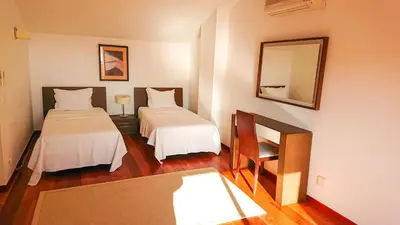 a hotel room with two beds and a mirror at Luxury 3-bedroom apartment at high-end Praia da Luz in Luz