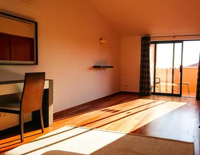 an empty living room with a table and a chair at Luxury 3-bedroom apartment at high-end Praia da Luz in Luz