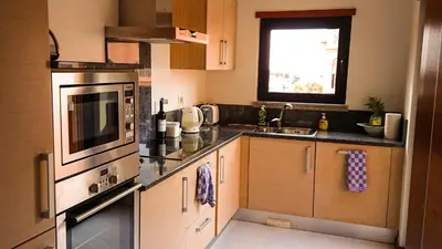 a kitchen with a sink and a stove top oven at Luxury 3-bedroom apartment at high-end Praia da Luz in Luz