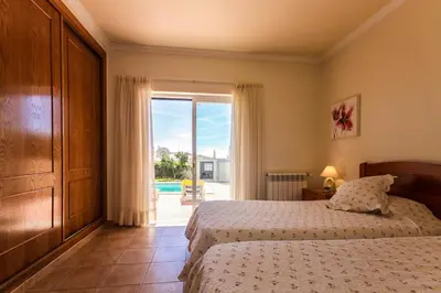 a bedroom with a bed and a large window at Villa Acacias 13 in Luz
