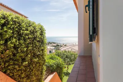 a balcony with a view of the ocean from a building at Villa Acacias 13 in Luz