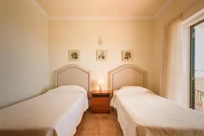 two beds sitting next to each other in a room at Villa Acacias 13 in Luz