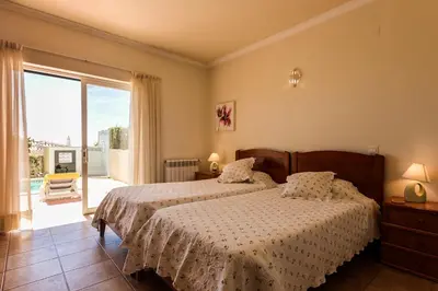 a bedroom with two beds and a large window at Villa Acacias 13 in Luz