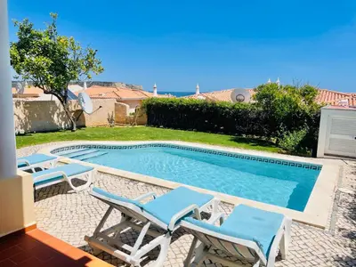 a swimming pool with two lounge chairs next to it at Villa Acacias 13 in Luz
