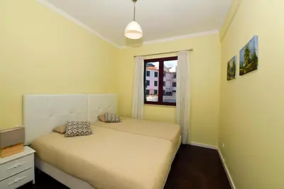 a bedroom with a bed and a window at Sol & Mar Camara de Lobos in Câmara de Lobos