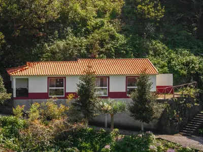 a house with an orange roof on a hill at Casas do Lanço by An Island Apart in São Vicente