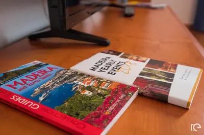 two magazines sitting on top of a wooden table at Apartamento Estefânia in Santa Cruz