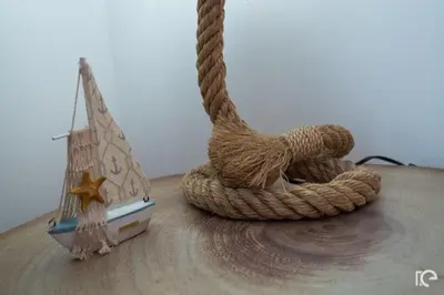 a wooden table with a rope and a small boat at Apartamento Estefânia in Santa Cruz