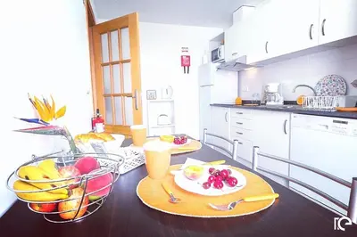 a kitchen with a table with a plate of fruit on it at Apartamento Estefânia in Santa Cruz